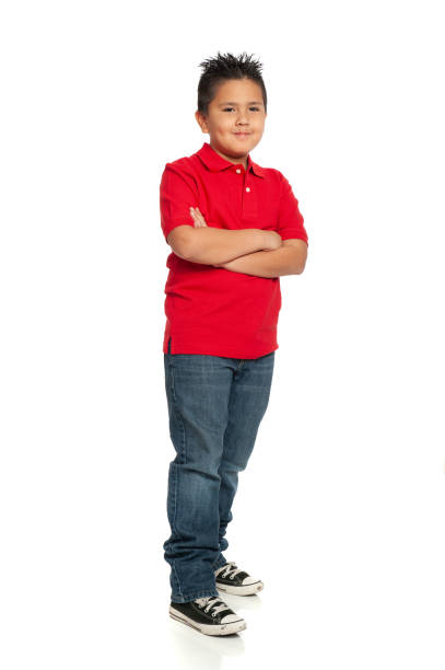 istock Nine year old Mexican boy standing up against white background 1264687341