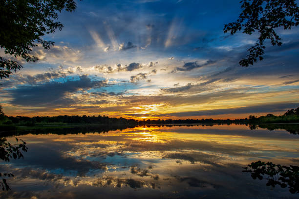 istock Sunbeams at Sunset over Quiet Lake 1264687759