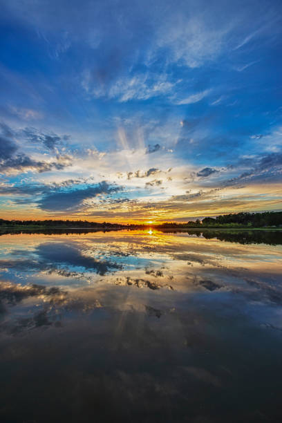 istock Vertical Image of Sunset with Sunbeams over Water 1264688932