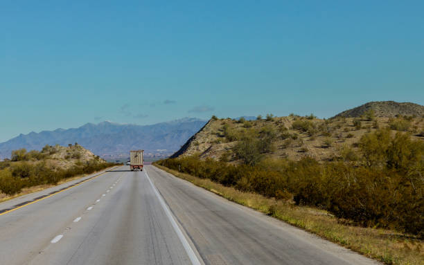 istock Big freight truck with flatbed going down the winding mountain road 1264690263