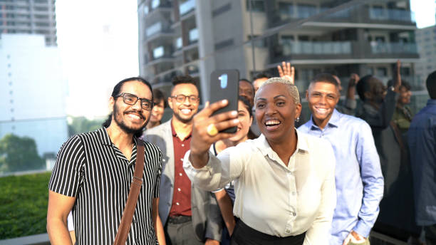 istock Business colleagues doing a video call / taking a selfie at work 1264692516