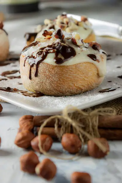 original cinnamon rolls with chocolate-cream sauce and hazelnuts