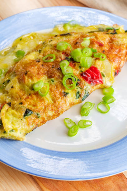 Spinach Peppers Spanish Omelette Spanish breakfast omelette filled with cheese spinach onions and peppers tortilla de patatas stock pictures, royalty-free photos & images
