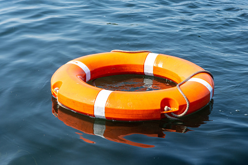 Lifebuoy in the blue water of the lake