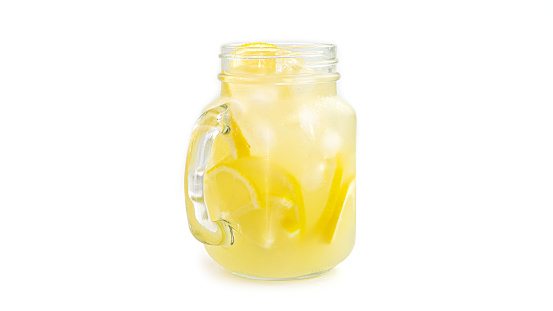 Mason jar with lemonade and ice on white background. Macro photo. High quality photo