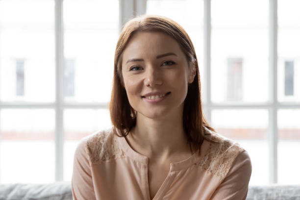 istock Head shot portrait smiling young woman looking at camera 1264699613
