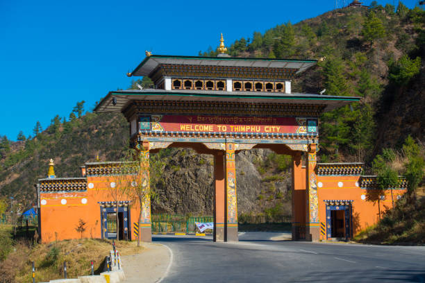 Welcome to Thimphu City Gate A huge entrance as you enter Thimphu in the Himalayan kingdom. buddhist prayer wheel stock pictures, royalty-free photos & images