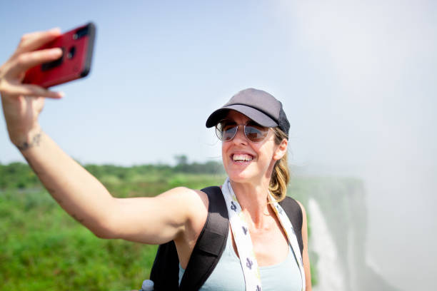 istock Tourist having fun in Iguazu falls and taking selfie 1264701615