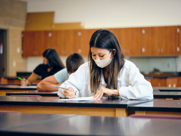 istock High School Students In Classroom Wearing Protective Face Mask 1264702960