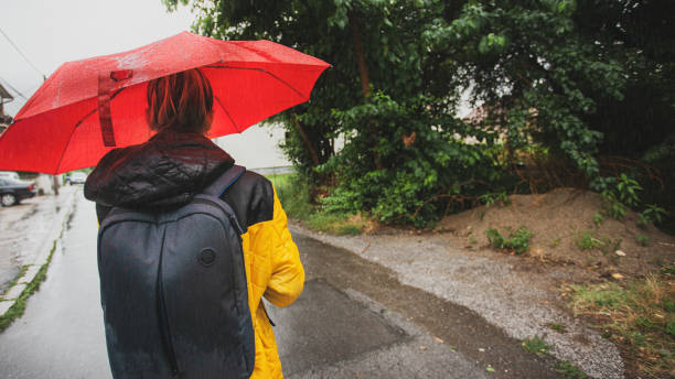 istock Beautiful woman on the street while raining 1264705666