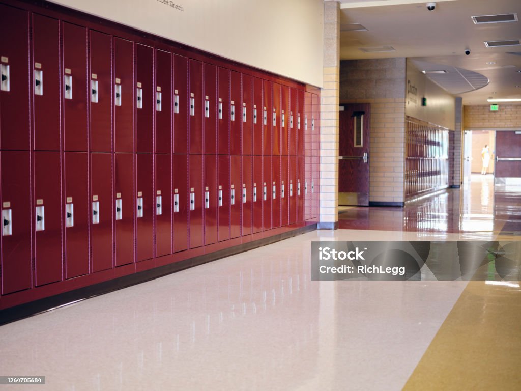 Empty High School Hallway An empty hallway with lockers in a high school. School Building Stock Photo