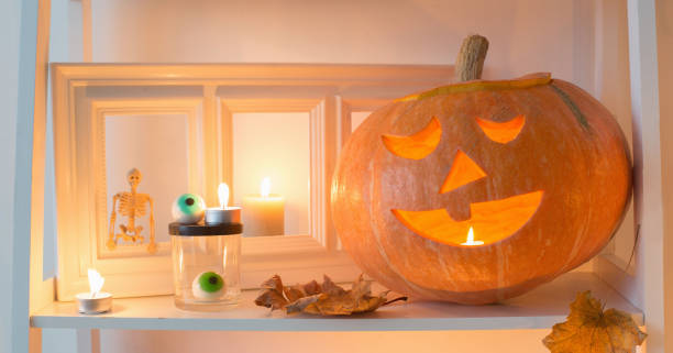 istock halloween pumpkins with candles on wooden table 1264705738