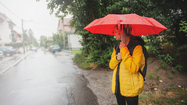 istock Beautiful woman on the street while raining 1264705755