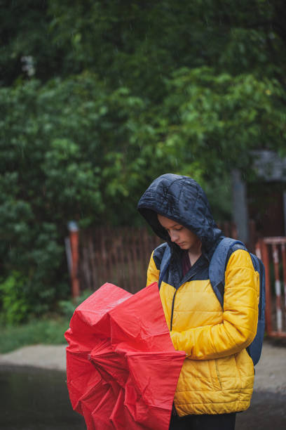 istock Beautiful woman on the street while raining 1264706486
