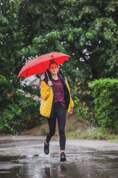 istock Beautiful woman on the street while raining 1264706807