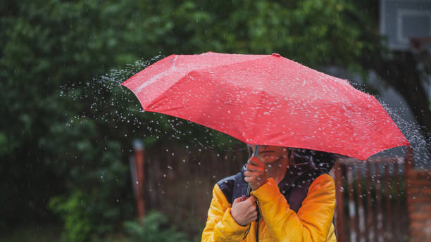 istock Beautiful woman on the street while raining 1264706829