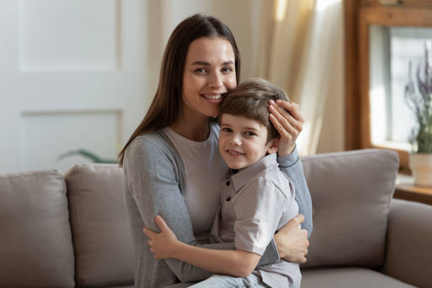 istock Loving affectionate young mother holding on lap little son. 1264706900