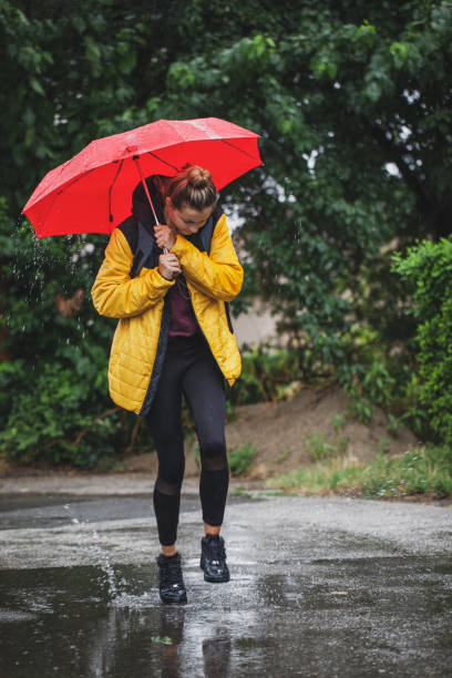 istock Beautiful woman on the street while raining 1264707671