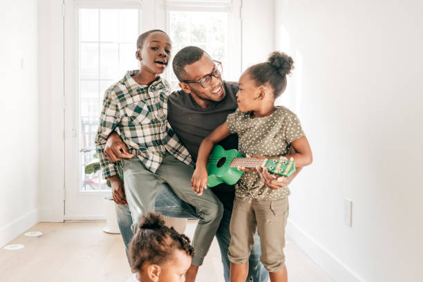 istock Dad is teaching kids new song 1264707675