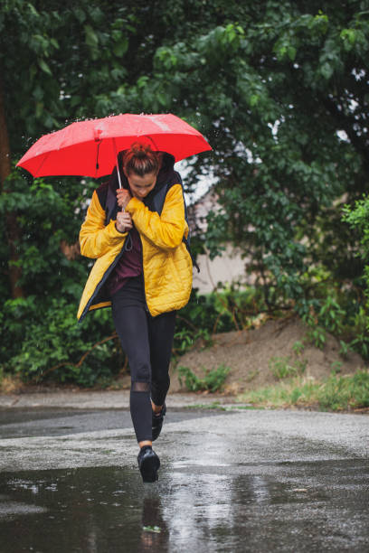 istock Beautiful woman on the street while raining 1264707741