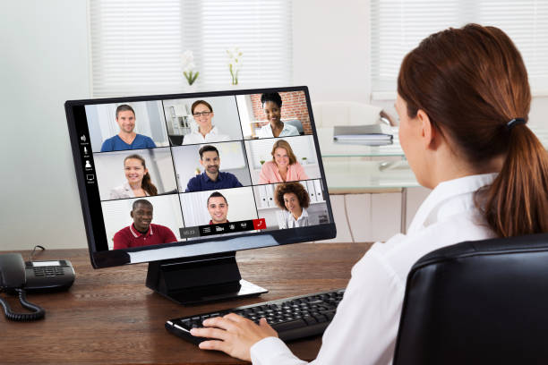 istock Businesswoman Videochatting With Colleagues On Computer 1264709816