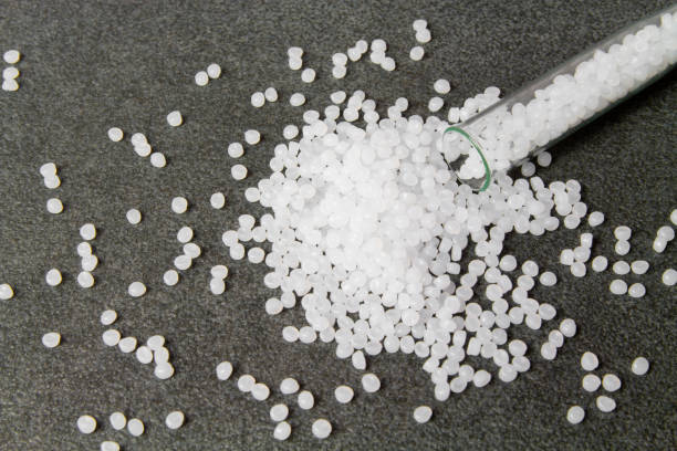 istock Plastic pallets. White Polyethylene granules on a stone background. Plastic Raw material .High Density Polyethylene. 1264709913