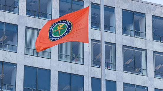Seal of the Federal Aviation Administration (FAA) on a waving flag out-front of the headquarters in Washington, D.C.