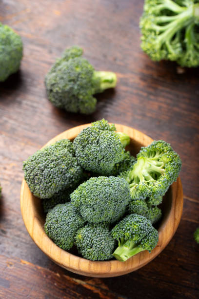 istock Fresh broccoli with in bowl on wooden table close up. 1264710797