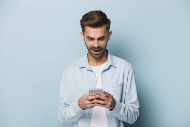 istock Close up portrait with handsome young man with mobile phone. 1264711390