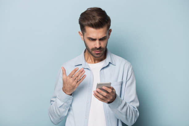 Close up portrait with handsome young man with mobile phone.