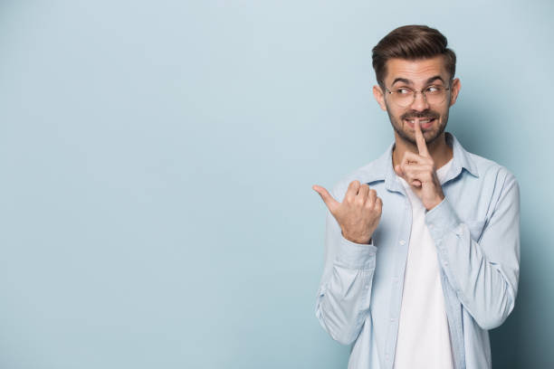 istock Close up portrait with handsome bearded man performing silence gesture. 1264711397