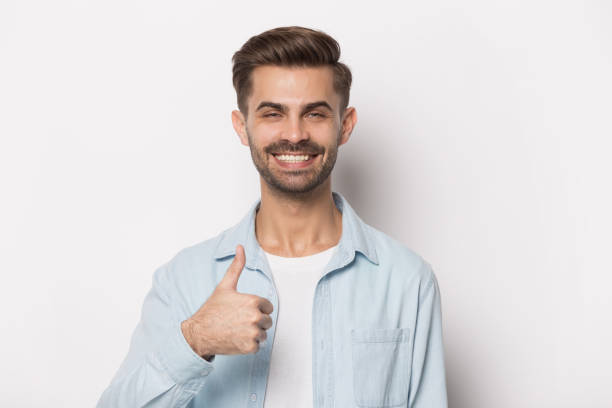 istock Close up portrait with smiling handsome bearded man thumbs up. 1264711409