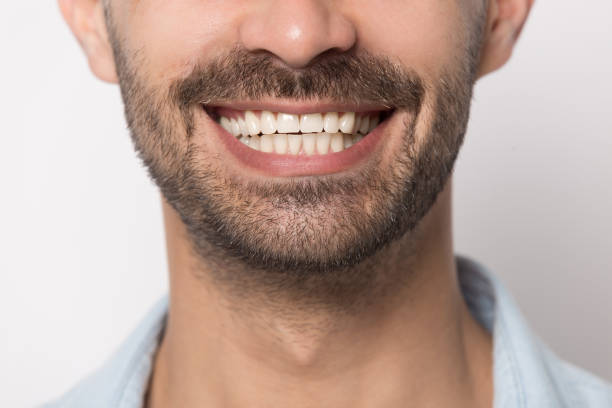 istock Close up smiling male mouth with white teeth. 1264711424