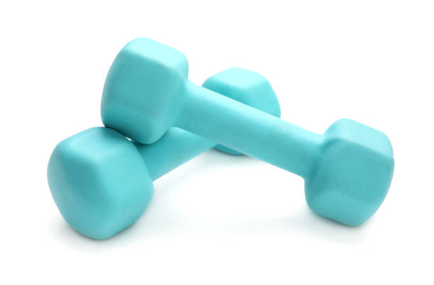 istock Two turquoise colored rubber dumbbells lying at white table 1264711462