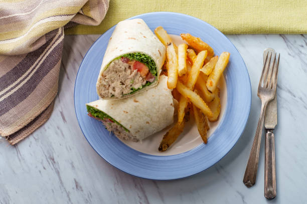 Tuna salad wrap sandwich with french fried potatoes