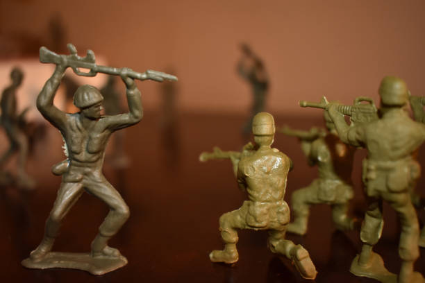 istock Toy Soldiers Doing Battle on a Wooden Surface 1264712825