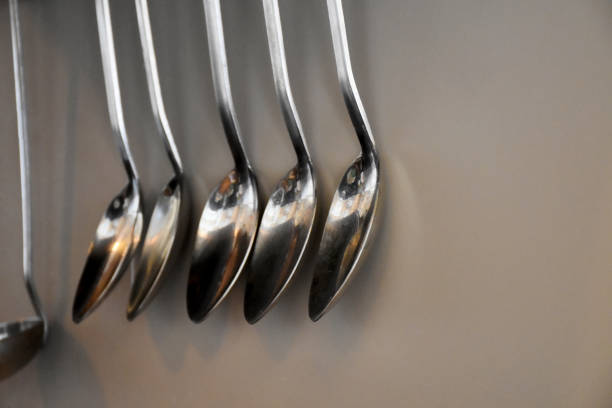Kitchen utensils, group of ladles, serving scoops hanging on the kitchen wall