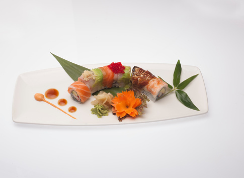 The famous far eastern food sushi served on a white plate.