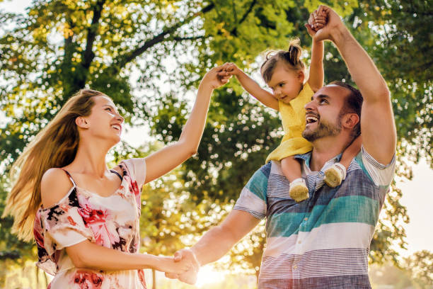 istock Family with daughter enjoying summer day 1264718607