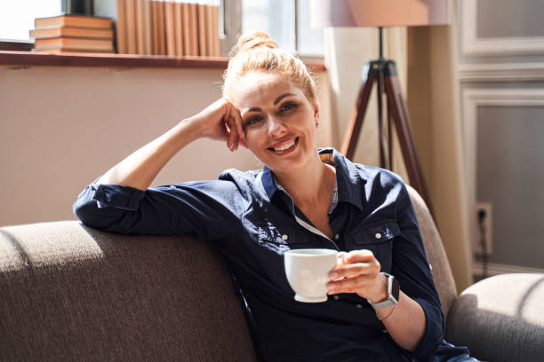 istock Positive young lady relaxing at home on sunny day 1264721337