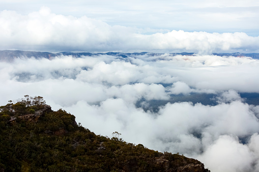 Mountains in the clouds, beautiful nature background with copy space, full frame horizontal composition