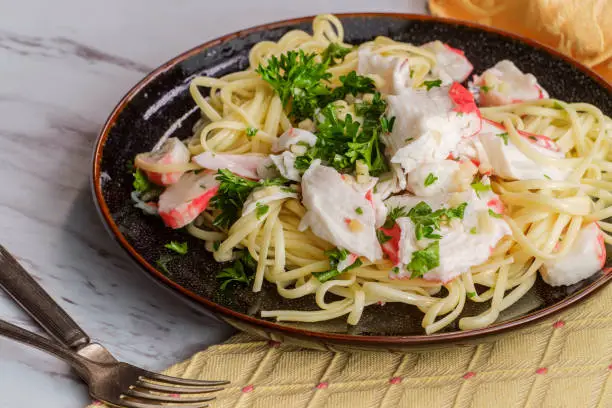 Italian crab scampi over linguine pasta with parsley garnish