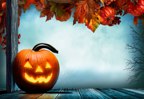 istock Jack O'Lantern On Porch Adorned With Autumn Leaves 1264724132