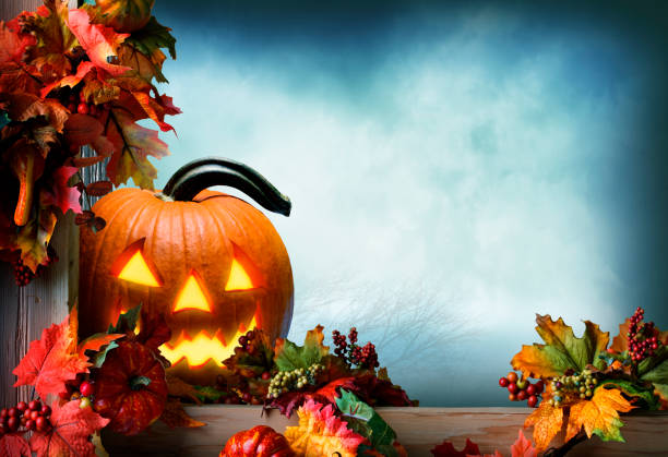 istock Jack O'Lantern On Fence Adorned With Autumn Leaves 1264724133