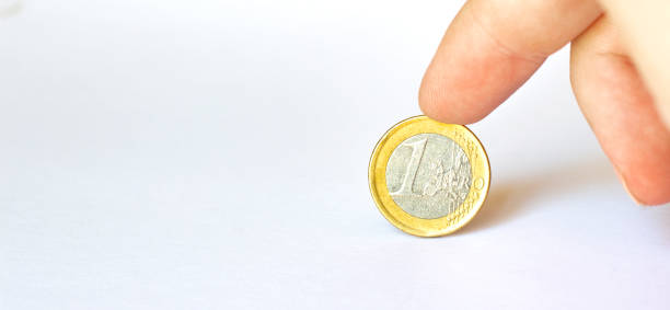 istock Man hand holding coin isolated on white background with clipping path. 1264725133