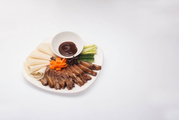 peking duck served in white plate on white background. - fine dining grilled spring onion healthy lifestyle imagens e fotografias de stock