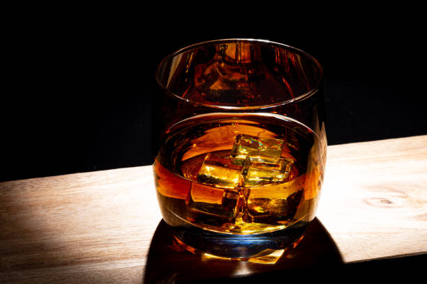 istock Glass of whiskey with ice 1264725977