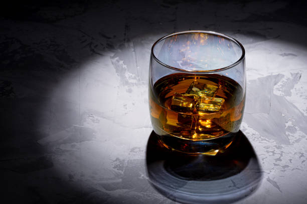 istock Glass of whiskey with ice 1264726046