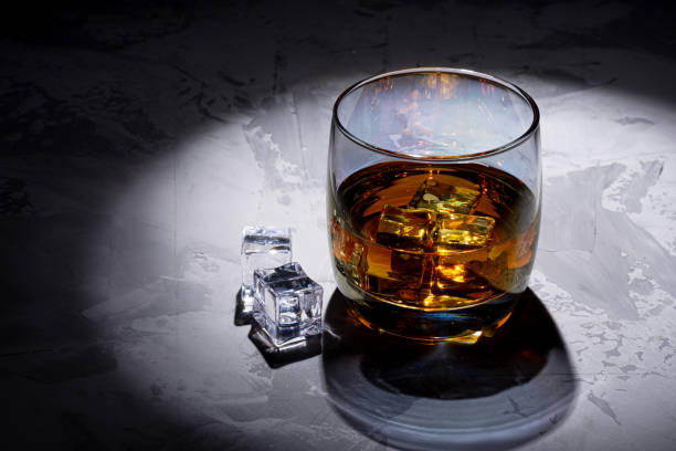 istock Glass of whiskey with ice 1264726070