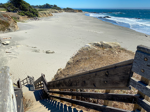 Beach access, stairs to ocean shore, La Jolla cove, California coast landscape, USA. Sea waves, cliff and green succulent ice plant. Water surface seascape, summer vacations, tourist waterfront resort